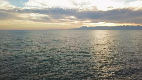 Beautiful Sunset at Beach with Golden Sun Reflection on the Sea