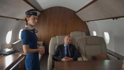 Private Jet Cabin with Businessman and Flight Attendant