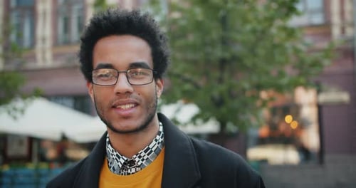 Close-up Portrait of Handsome African American Man Looking at Camera with Smile