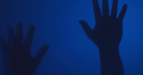 Silhouetted Hands Reaching Up on Blue