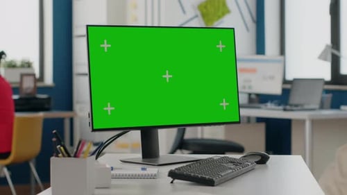 Close Up of Computer with Isolated Green Screen at Empty Desk