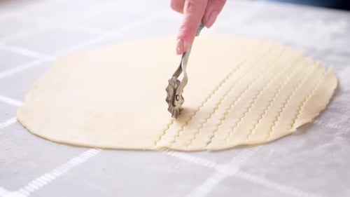 Apple Pie Cake Preparation Series Woman Slicing Rolled Dough with Rolling Knife