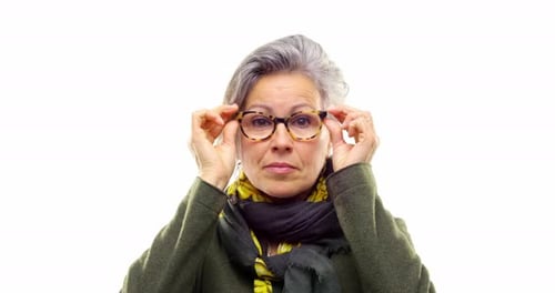 Senior Woman Putting on Glasses, Portrait