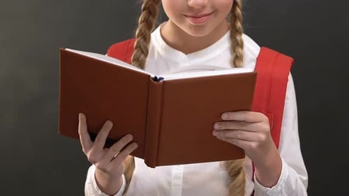 Blonde Schoolgirl Reading a Book Close Up