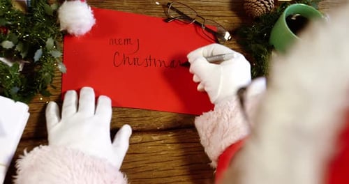 Writing a Christmas Card at a Wooden Desk