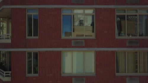 Ascending Fly Along Red Brick Wall with Windows