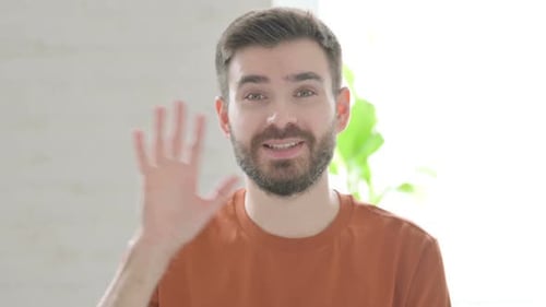 Man Waving Hello with a Friendly Smile