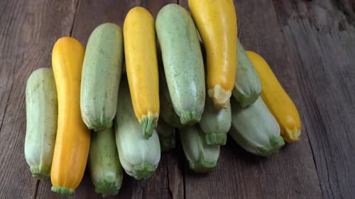 A Set of Multicolored Zucchini Yellow Green White Orange on the Table Closeup