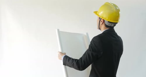 Businessman Looking Into Blueprint