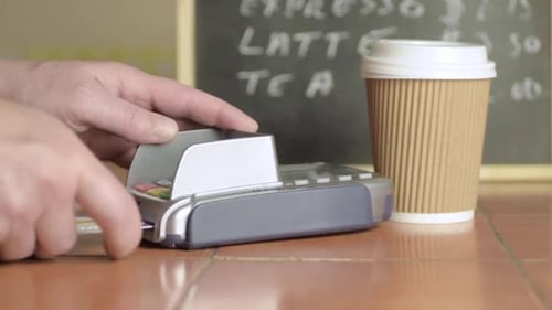Hand paying by card in cafe medium shot
