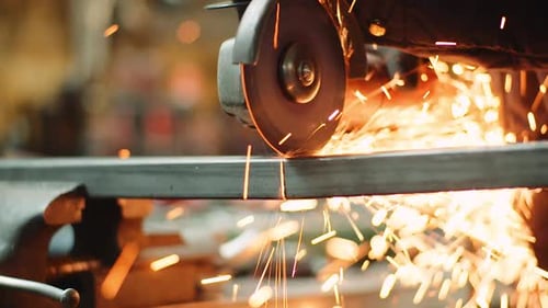 Angle Grinder Cutting Metal at Workshop