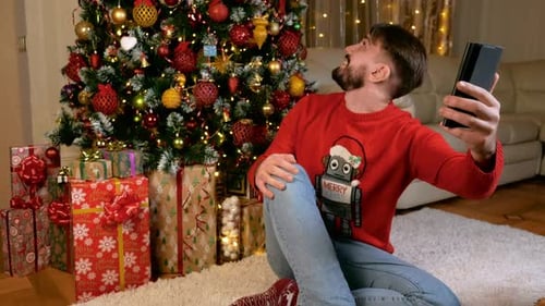 Cheerful Man Video Calling Near Decorated Christmas Tree