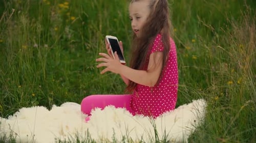 Girl Talking on Smartphone in Grassy Field