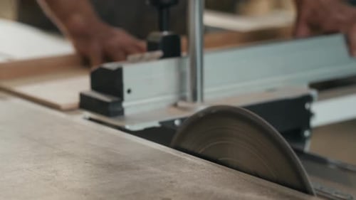 Saws Furniture Details with a Circular Saw. Close Up View of Man Wooden Production Factory Furniture