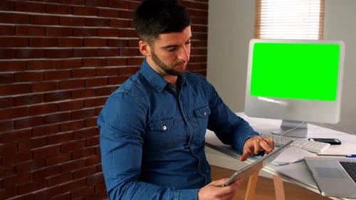 Male graphic designer using digital tablet