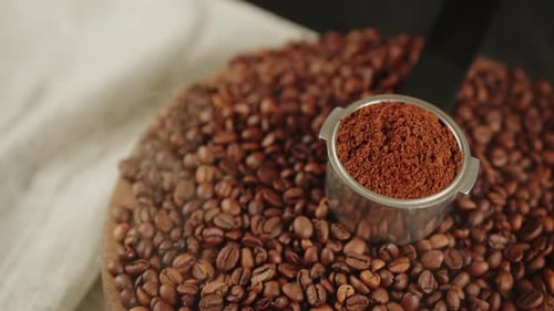Coffee Grounds in a Portafilter Surrounded by Beans