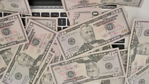 Fifty Dollar Bills Covering Laptop Keyboard