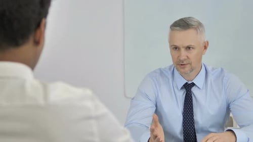 Senior Businessman Talking with African Businessman in Office, Interview