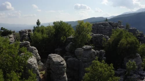 Top View of Beautiful Grey Rock Formations Among Green Trees