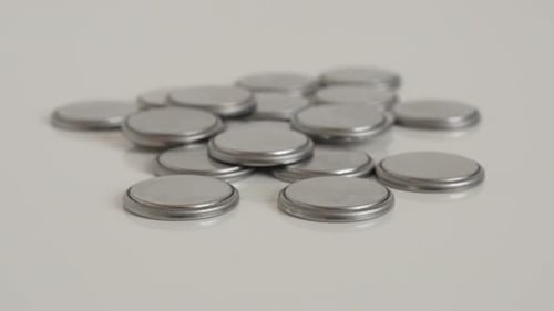 Slow tilt on pile of cell batteries close-up 4K video