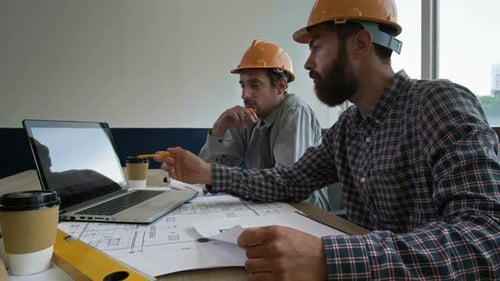 Two Engineers Working Together in Office