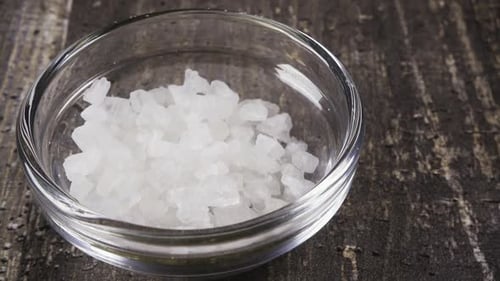 Slow Motion Sea Salt Pour Into a Bowl Close Up