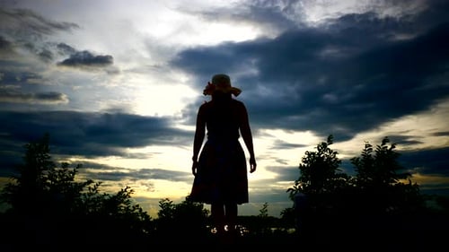 Beautiful Young Woman standing with arms raised enjoy in nature