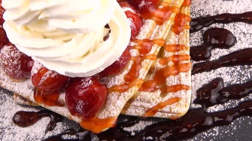 Waffles with strawberries and whipped cream