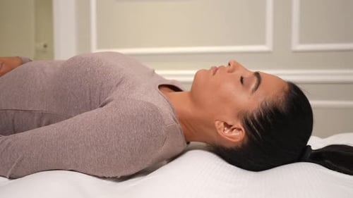 Woman Lying Down on a Bed Relaxing
