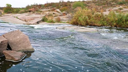 A Small Shining Stream Flows Among Smooth Wet and Dark Stones
