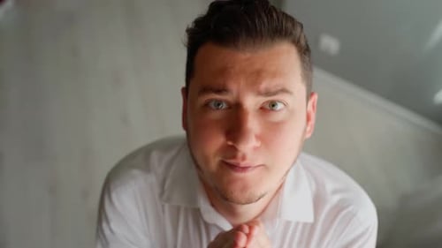 Scared man office worker afraid boss looking at camera praying. Man is shocked and very frightened