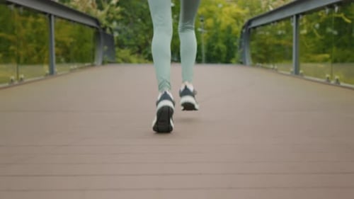 Close-up woman feet running, back view.