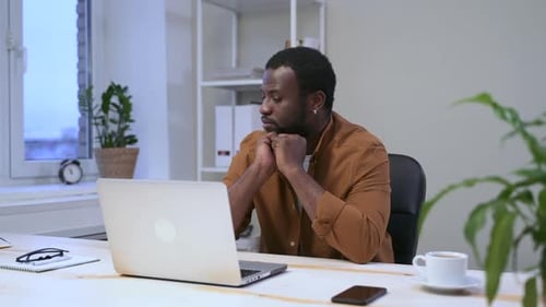 Portrait of Businessman Working with Laptop and Sitting at Table in Modern Office Spbas