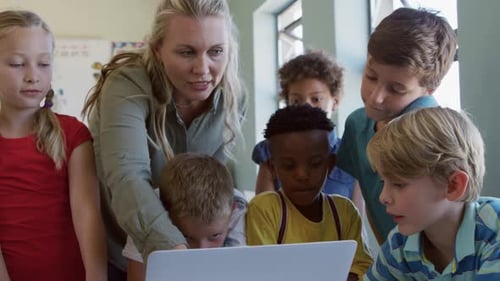 Teacher Explains Lesson to Elementary School Students