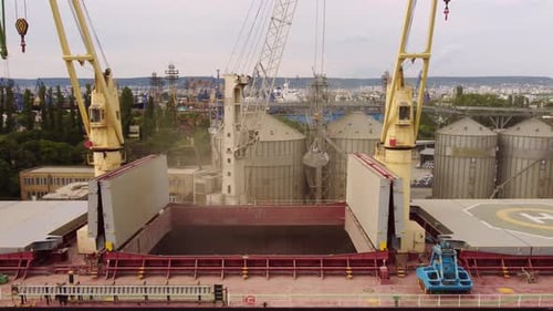 Loading Grain Into Sea Cargo Vessel in Seaport From Silos of Grain Storage