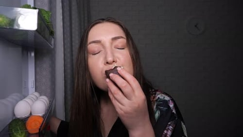 Woman Enjoys Dessert at Refrigerator Late at Night
