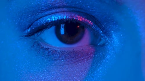 Female Eye with Shiny Arrows Looking Straight. Close Up Macro Portrait