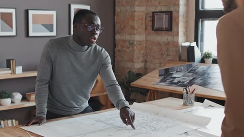 Black Architect Talking to Colleague