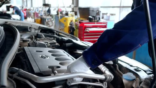 Automechaniker überprüft das Motoröl des Autos
