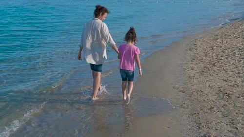Family walks on the beach.