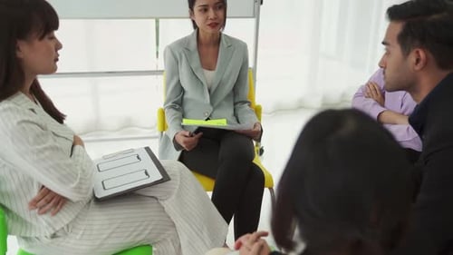 Business People Proficiently Discuss Work Project While Sitting in Circle