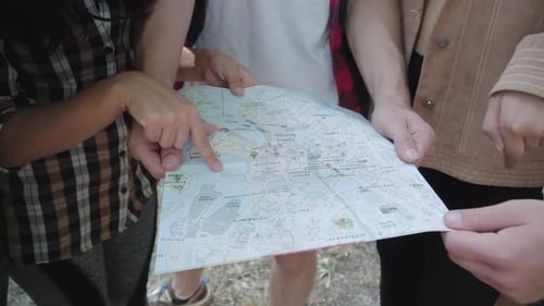 People Planning Trip Using City Street Map
