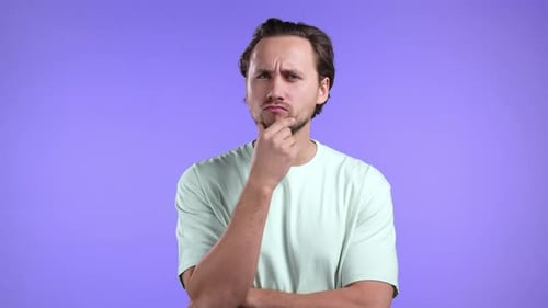 Man Ponders Intensely on Purple Background