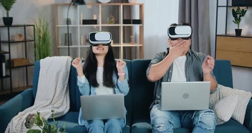 Couple Experiencing Virtual Reality in Living Room