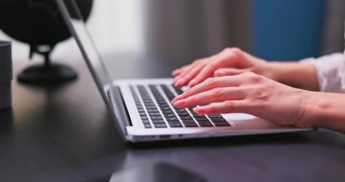 Close Up Neat Hands of a Young Woman Type on a Laptop Keyboard