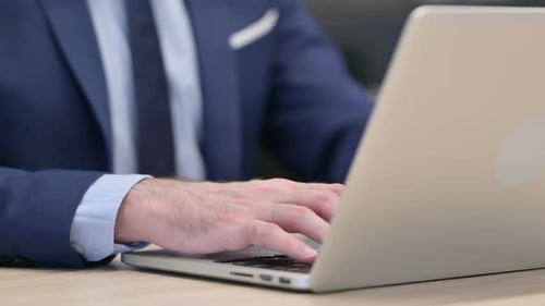 Hands Close Up of Middle Aged Businessman Typing on Laptop