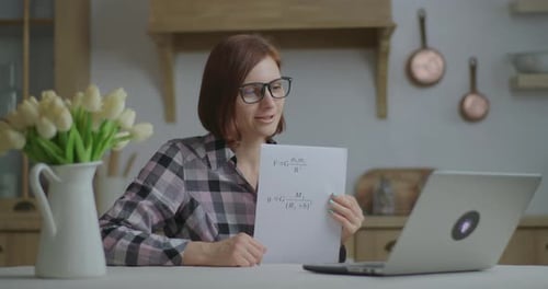 Woman Teaching Online Science Class at Kitchen Table