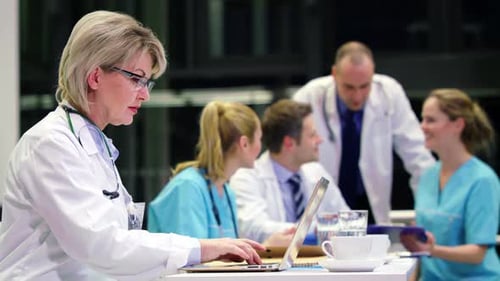 Medical Professionals Collaborating at Table in Hospital Setting