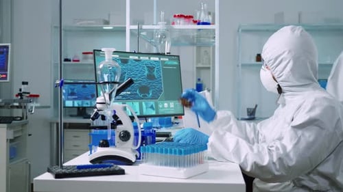 Scientist in Hazmat Suit Working in Lab