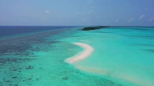 Wide angle fly over copy space shot of a sunshine white sandy paradise beach and aqua blue ocean